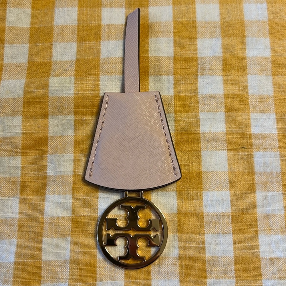Tory Burch pink and gold logo charm leather cut but Charm can still be used.